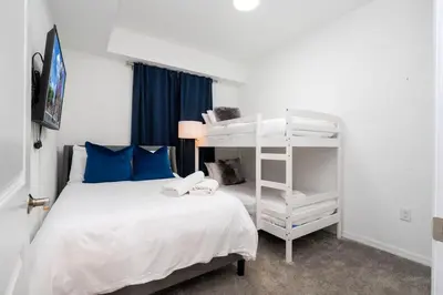 a bedroom with a bed and a bunk bed at 3191 Unit 207 Stunning apartment in Kissimmee