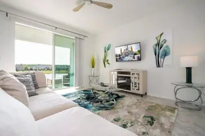 a living room with a white couch and a window at 3191 Unit 207 Stunning apartment in Kissimmee