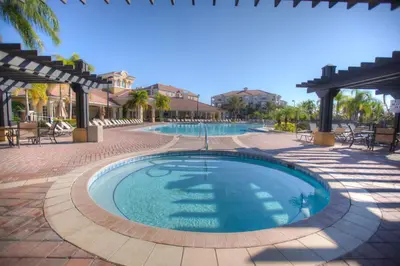a swimming pool in a resort with tables and chairs at 4814 Cayview Avenue 406 in Orlando