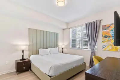 a bedroom with a bed and a desk and a window at 4012 Breakview Drive 210 in Orlando