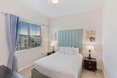 a bedroom with a large bed and a window at 4012 Breakview Drive 410 in Orlando