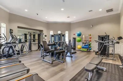 a gym with treadmills ellipticals and exercise machines at 4012 Breakview Drive 410 in Orlando