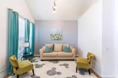 a living room with a couch and two chairs at 8213 Fan Palm Way in Kissimmee