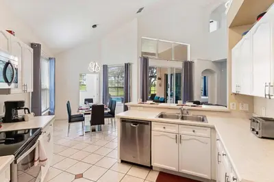 a kitchen with a sink and a counter top at 8213 Fan Palm Way in Kissimmee