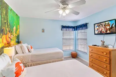a bedroom with two beds and a ceiling fan at 8213 Fan Palm Way in Kissimmee