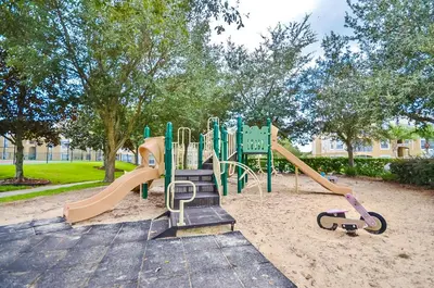 a playground in a park with a slide at 8213 Fan Palm Way in Kissimmee