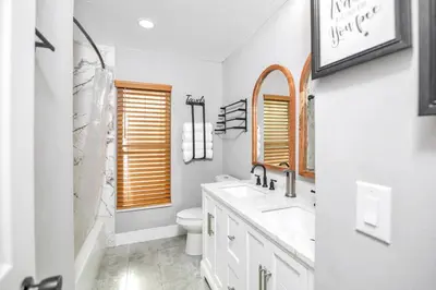 a white bathroom with a sink and a toilet at Home away from home in Orlando! in Orlando