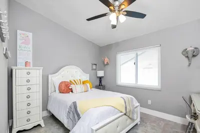 a bedroom with a bed and a ceiling fan at Home away from home in Orlando! in Orlando