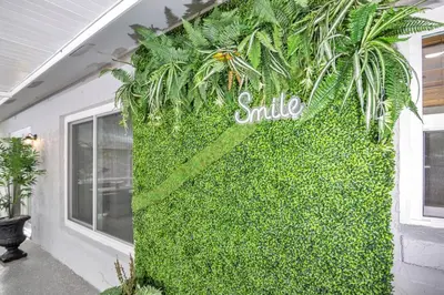 a wall covered in green ivy next to a building at Home away from home in Orlando! in Orlando