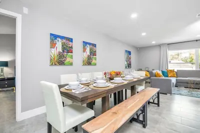 a dining room with a table and a couch at Home away from home in Orlando! in Orlando