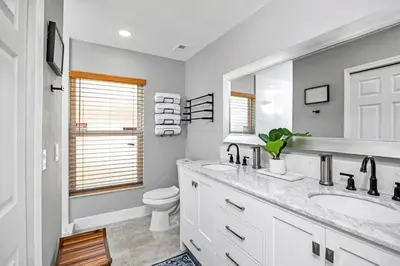 a bathroom with a sink and a toilet and a mirror at Home away from home in Orlando! in Orlando