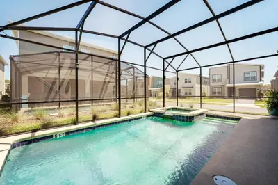 an indoor swimming pool with a glass enclosure at New Beautiful 7 br w pool games theme rooms in Kissimmee