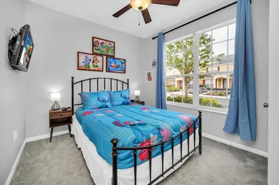 a bedroom with a bed and a window at Townhome near Disney with pool Magic and Fun at Windsor in Orlando