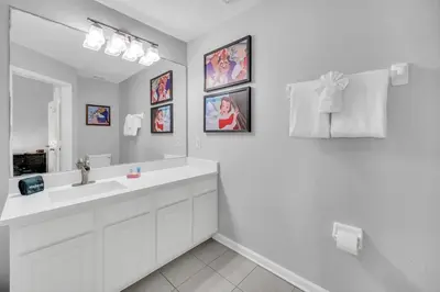 a white bathroom with a sink and a mirror at Townhome near Disney with pool Magic and Fun at Windsor in Orlando