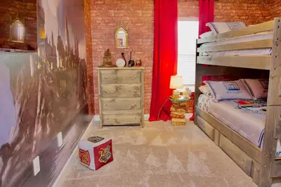 a bedroom with a wooden bunk bed and a dresser at Cozy & Magical place sleeps 12/10 min from Disney in Kissimmee