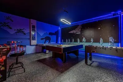 a ping pong table in a room with blue lights at Lake View Vacation Home with Pool and Game Room Near Disney Parks in Kissimmee