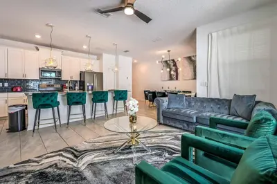 a living room with a couch and a table at Relax in Style at this Spacious 4-Bedroom Villa in Kissimmee