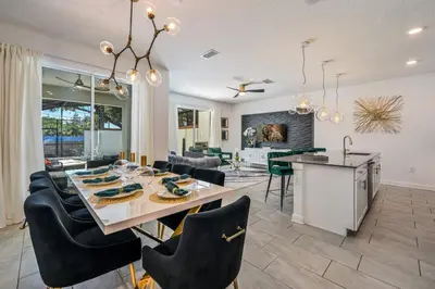 a dining room and living room with a table and chairs at Relax in Style at this Spacious 4-Bedroom Villa in Kissimmee