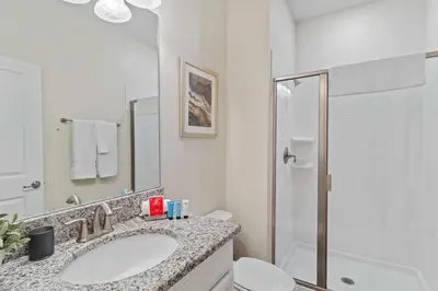 a bathroom with a sink and a toilet and a shower at 4813 Crusoe Street in Kissimmee