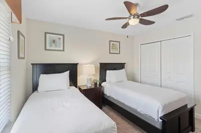 a bedroom with two beds and a ceiling fan at 4813 Crusoe Street in Kissimmee