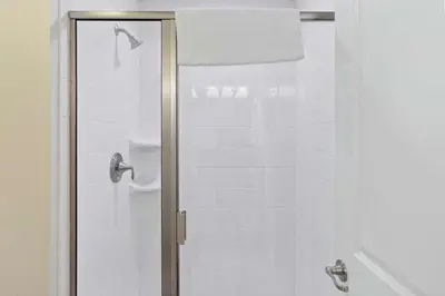 a shower with a glass door in a bathroom at 4813 Crusoe Street in Kissimmee