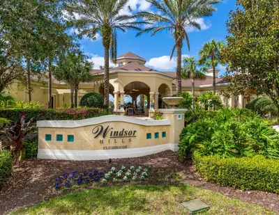 a house with a sign in front of a yard at Dream Cozy 3BR Condo - Disney 5 Min Walk to Pool in Orlando