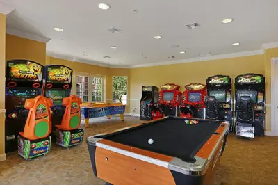 a games room with a pool table and arcade machines at Epic Universe Beautiful Condo, Vista Cay, Orlando-3026 in Orlando