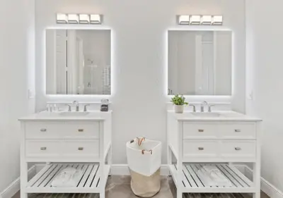 a bathroom with two sinks and two mirrors at Luxury Lakeview Penthouse, Vista Cay Orlando 1025 in Orlando