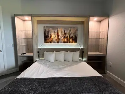 a bedroom with a white bed with a painting above it at Luxury Lakeview Penthouse, Vista Cay Orlando 1025 in Orlando