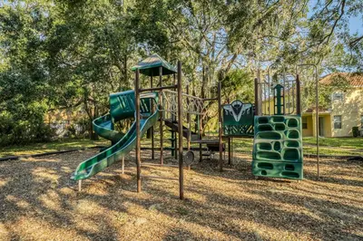 a playground with a slide in a park at Compass Point Villa S in Kissimmee
