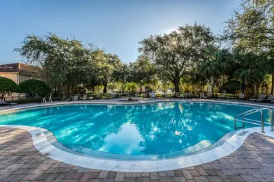 a large swimming pool with blue water at Compass Point Villa S in Kissimmee
