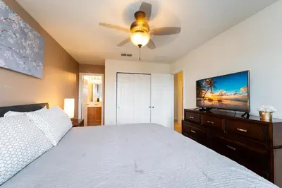 a bedroom with a bed and a ceiling fan at Compass Point Villa S in Kissimmee