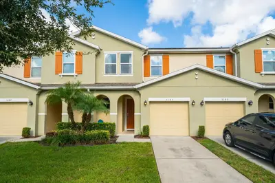 a house with a car parked in front of it at Compass Point Villa S in Kissimmee