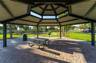 a picnic shelter with a bench in a park at Compass Point Villa S in Kissimmee