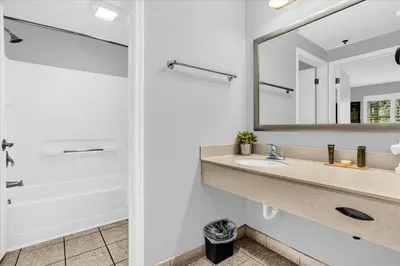 a bathroom with a sink and a mirror at Family Friendly 1BR Suite with Swimming Pool - Near Disney in Orlando