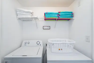 a laundry room with a washing machine and towels at Making Memories G in Kissimmee