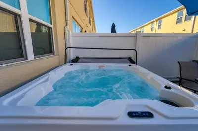 a hot tub sitting on the side of a building at Making Memories G in Kissimmee