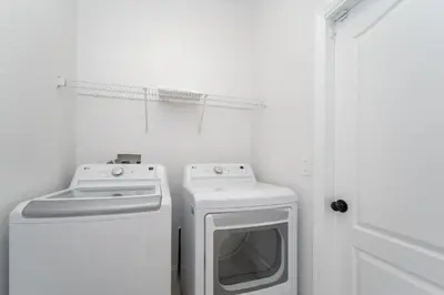 a white laundry room with a washer and dryer at Lakeview Villa G in Orlando