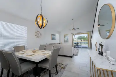a dining room and living room with a table and chairs at Lakeview Villa G in Orlando