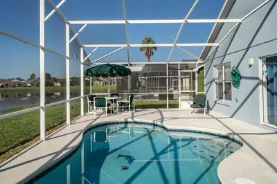 a swimming pool in a house with a glass ceiling at Eagle's End S in Kissimmee