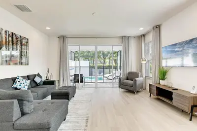 a living room with a couch and a tv at 4 bedrooms pool home Hidden Forest Resort Amenities in Orlando