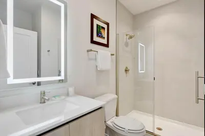 a bathroom with a sink and a toilet and a shower at 4 bedrooms pool home Hidden Forest Resort Amenities in Orlando