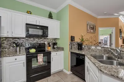 a kitchen with a sink and a stove top oven at 3 bedrooms townhome Gated Resort 5 minutes from Disney in Orlando