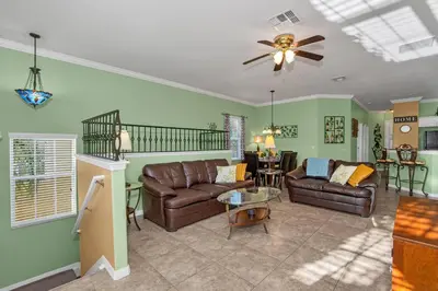 a living room with two couches and a ceiling fan at 3 bedrooms townhome Gated Resort 5 minutes from Disney in Orlando