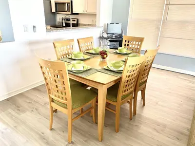 a dining room table with four chairs and a table and chairsktop at LB4707AW 3 Bedroom Villa with pool and game room in Kissimmee