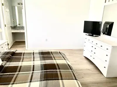 a bedroom with a bed and a tv on a dresser at LB4707AW 3 Bedroom Villa with pool and game room in Kissimmee
