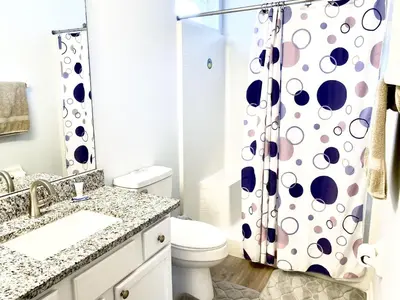 a bathroom with a toilet and a shower curtain at LB4707AW 3 Bedroom Villa with pool and game room in Kissimmee