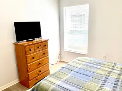 a bedroom with a bed and a television on a dresser at LB4707AW 3 Bedroom Villa with pool and game room in Kissimmee