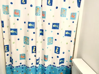 a shower curtain with cartoon characters on it in a bathroom at LB4707AW 3 Bedroom Villa with pool and game room in Kissimmee