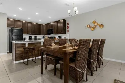 a kitchen with a dining room table and chairs at 4732TH Cozy home in Kissimmee in Kissimmee